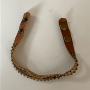 Brown bracelet with grommets